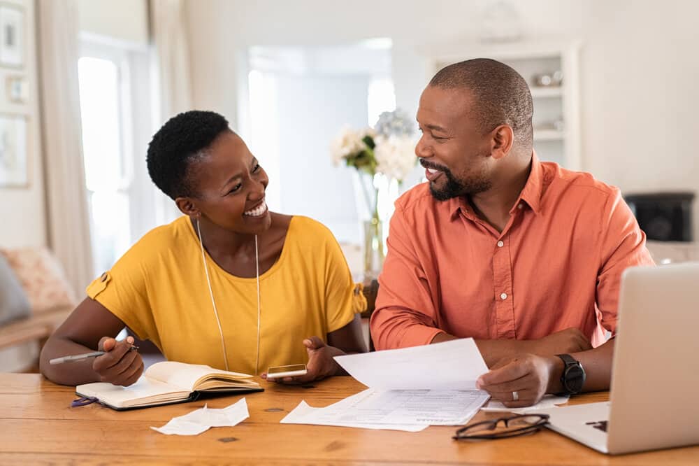 cheerful mature couple managing finances together